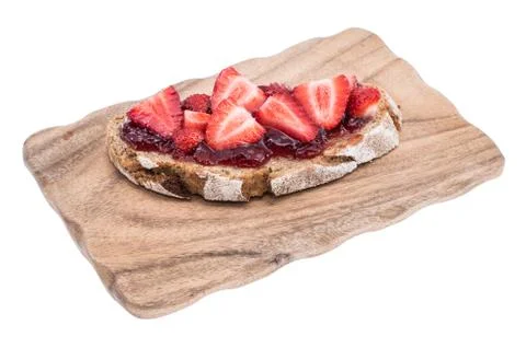 Bread with strawberry jam on cutting board Stock Photos
