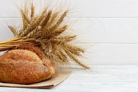 Bread on the table, homemade bread with wheat on a wooden background Stock Photos