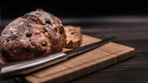 Bread on a table with a knife Stock Photos