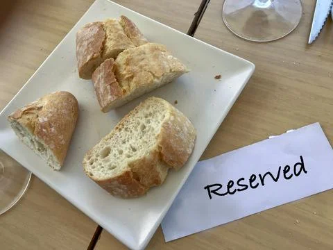 Bread on the table with the reserved sign Stock Photos