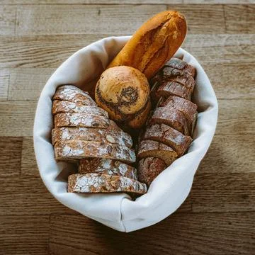 Bread in textile natural bread box on wooden boards Stock Photos