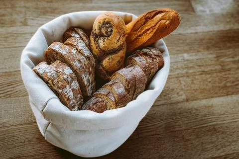 Bread in textile natural bread box on wooden boards Stock Photos