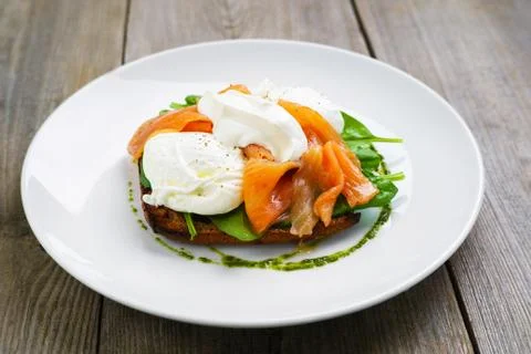 Bread toast and poached egg with smoked salmon Stock Photos