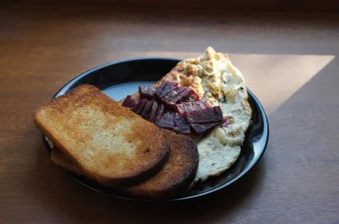Bread toasts with vegetables and scrambled eggs Stock Photos