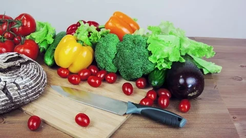 Bread tomatoes knife on a wooden table. Stock Footage 83997743