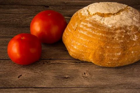 Bread with tomatoes on a wooden table Stock Photos