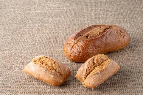 Bread, traditional sourdough bread, on a background of burlap Stock Photos
