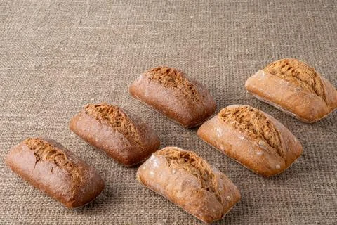Bread, traditional sourdough bread, on a background of burlap Photos