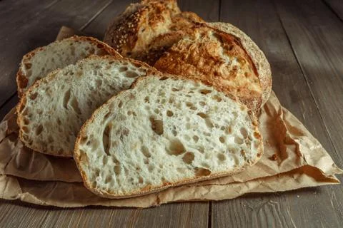 Bread, traditional sourdough bread cut into slices on a rustic wooden backgro Foto stock