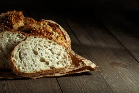 Bread, traditional sourdough bread cut into slices on a rustic wooden backgro Stock Photos
