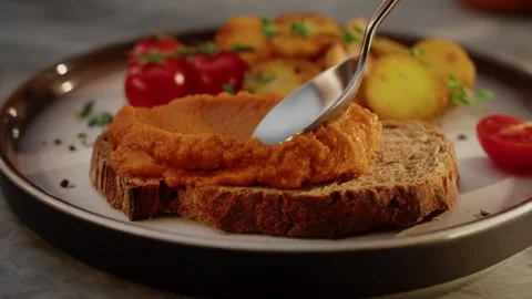 Bread with vegetable spread and baked potatoes on plate 스톡 동영상 316846062