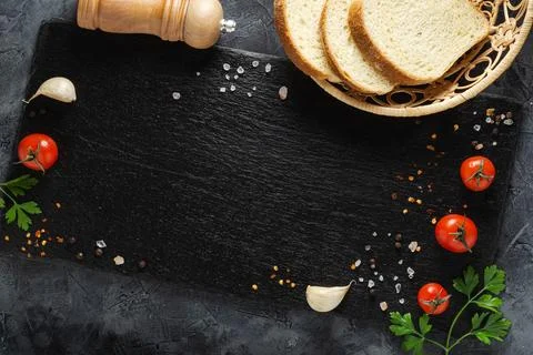 Bread with vegetables on slate board. Copy space. Top view. Stock Photos