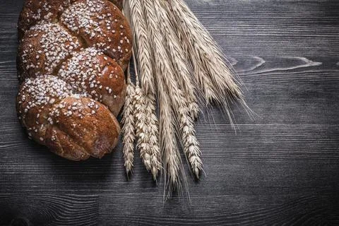 Bread wheat and rye ears on wooden board 스톡 사진