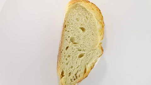 Bread  white, cut piece, rotation, turning clockwise, on white background Stock-Footage 148885101