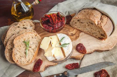 Bread whole wheat processed cheese Camembert with sun-dried tomatoes with ros Stock Photos
