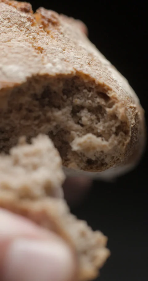 Bread wholegrain opening with hands slow motion Stock Footage 280519330