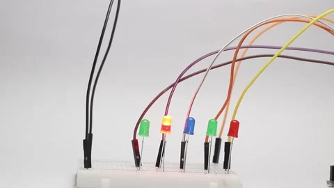 Breadboard circuit consisting of different color LED lights that blink Stock Footage 327978417
