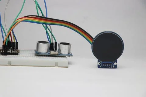 Breadboard circuit with jumper cables connected to ultrasonic distance sensor Stock Photos