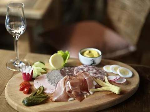 Breadboard with cold cuts and appetizers Stock Photos