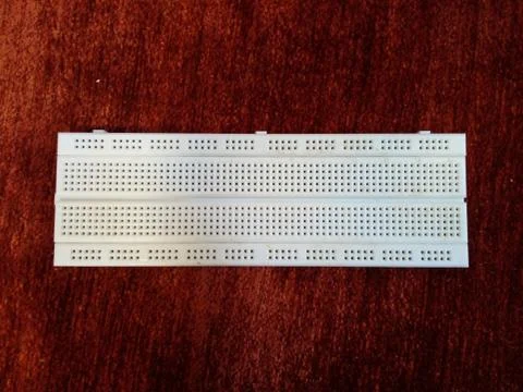 Breadboard electronic equipment on red background Stock Photos