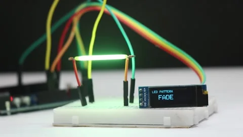 Breadboard electronics with LED filament showing blink, fade, and pulse Stock Footage 336626375