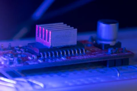 Breadboard prototyping board red microcontroller radiator in blue and red lig Stock Photos