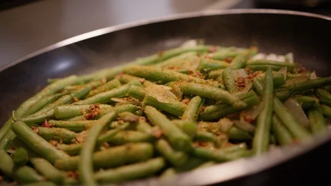 Breadcrumbs being sprinkled on pan of grean bean casserole Stock Footage 124224676