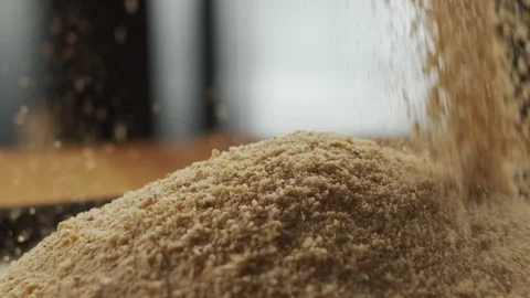 Breadcrumbs sprinkle onto the kitchen table. Slow motion video Video stock 116162681