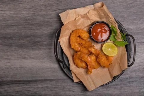Breaded and breaded shrimp with chilli sauce on black background Stock Photos
