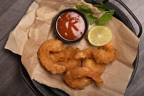 Breaded and breaded shrimp with chilli sauce on black background Stock Photos
