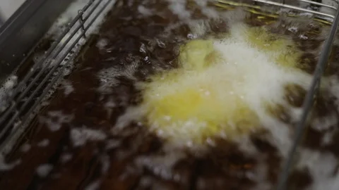 Breaded Brie Going Into a Deep Fryer Stock Footage 129327972