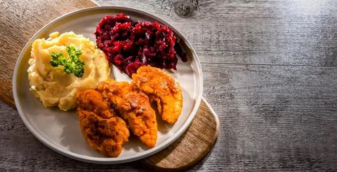 Breaded chicken cutlets served with potatoes and beetroot Stock Photos