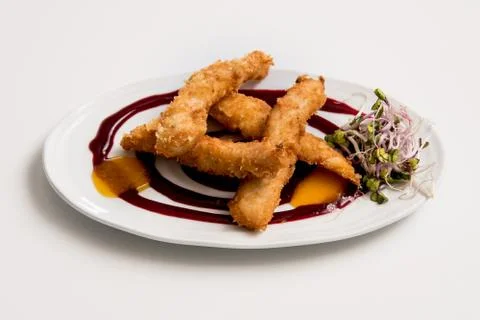 Breaded chicken dish on a white background Stock Photos