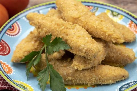 Breaded chicken fillets on a plate Stock Photos