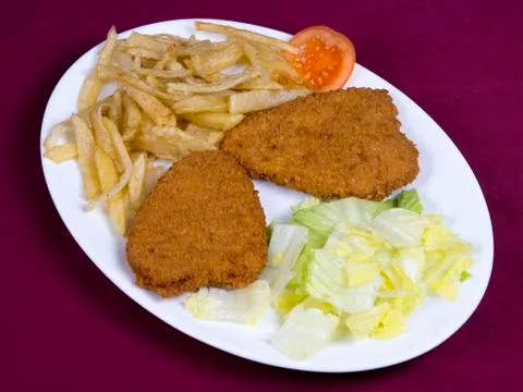 Breaded chicken fillets with potatoes Stock Photos