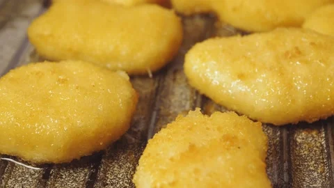 Breaded chicken nuggets are fried in a pan in oil. Stock Footage 172043205