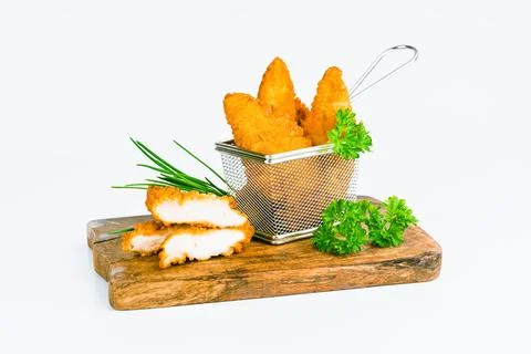 Breaded chicken nuggets. Breaded Chicken Inner Fillet with green lettuce leaves Foto stock