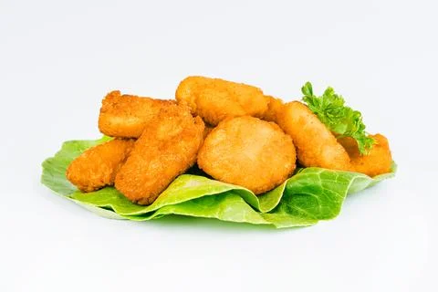Breaded chicken nuggets. Breaded Chicken Inner Fillet with green lettuce leaves Stock Photos