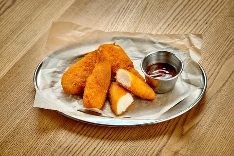 Breaded chicken nuggets. A selective trick. Close-up. Noise added in post-pro Stock Photos