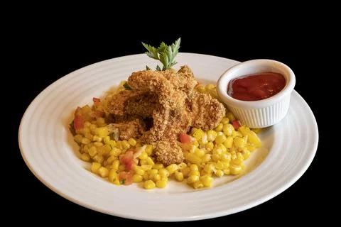Breaded chicken wings with boiled corn and ketchup. Food on a white plate i.. Stock Photos