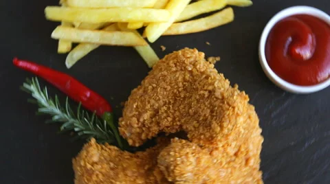 Breaded crispy chicken wing nuggets fried  sauce french fries food dish Stock Footage 68116911