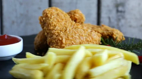 Breaded crispy chicken wing nuggets fried sauce french fries food dish Stock Footage 68140646