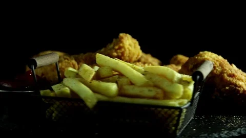 Breaded crispy fried chicken legs and wing, french fries,  rotation 360 degrees. Stock Footage 124158590