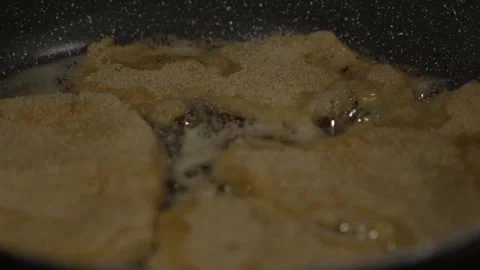 Breaded Cutlets Frying Sizzling in Hot Oil Bubbles in Skillet Close-up Cook.. Stock Footage 331544055