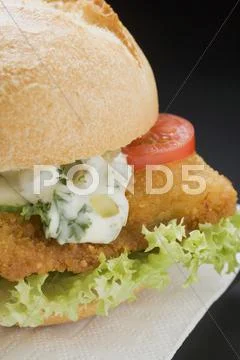 Breaded escalope in roll with remoulade Stock Photos