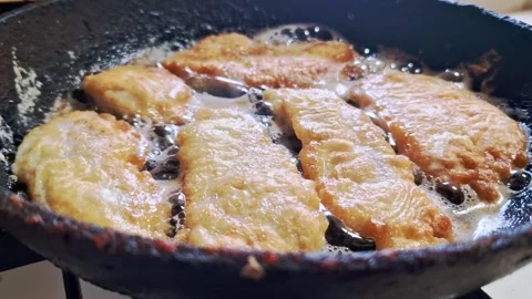 Breaded Fish Fillets Frying in Cast Iron Pan Stock Footage 321961665