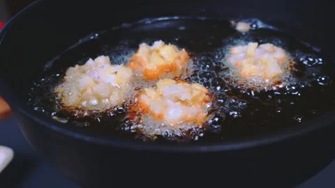 Breaded Fish Fillets Frying in Hot Oil in a Kitchen Pan Close-Up Stockbeeldmateriaal 342849259