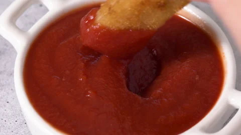 Breaded fish stick dipped in ketchup Stock Footage 223338445