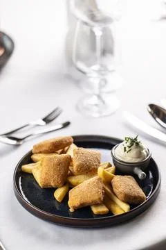 Breaded fried cheese with chips and mayonnaise Stock Photos