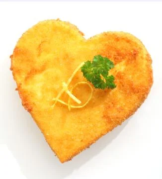 Breaded fried cheese or fish in heart shape Stock Photos